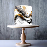 Abstract wave pattern in black, white, and gold edible cake topper decoration