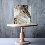 Geode-inspired black, white, and gold marble pattern edible cake topper decoration