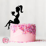 Pregnant sitting girl holding heart silhouette cake topper